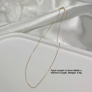 Detailed macro view of a fine 0.4mm gold plated S925 silver box chain with 450mm length