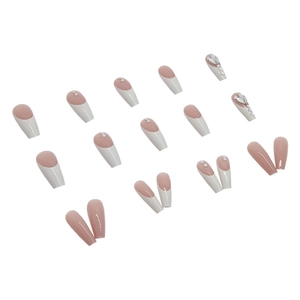 Long coffin press-on nails with nude pink french design, white pearls, and rhinestones