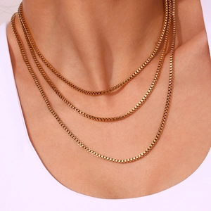 Three-layered golden stainless steel Venetian box chains worn by a female model