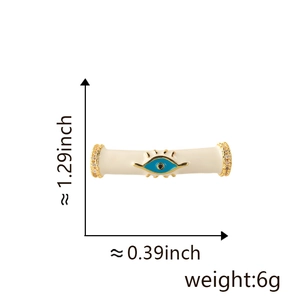 Detail of 18k gold evil eye charm with cream enamel, crystal inlay and measurements
