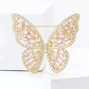 Close-up of luxury copper butterfly brooch with micro-paved pink gems and zircons