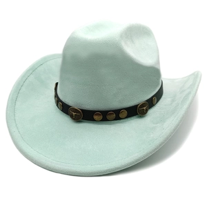 Close-up of mint green suede cowboy hat featuring vintage bull head metal badge and studs