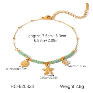 Detail of 18K gold stainless steel bracelet with starfish, shell, and mint green stone