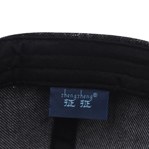 Close-up of internal lining and woven brand label on washed vintage baseball cap
