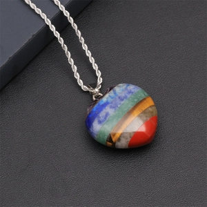 Handcrafted heart pendant necklace featuring multi-layered natural chakra crystals on a silver chain