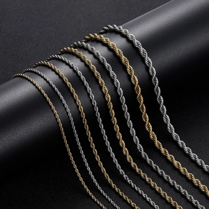 Polished gold and silver stainless steel rope chains displayed on black display stand