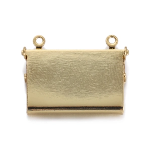 Detail of gold-plated heart hexagonal pendant with a brushed metal texture finish