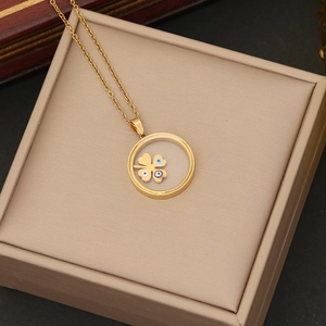 Detail of gold Evil Eye necklace with clover charms in a premium gift box setup
