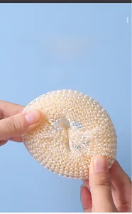 Detailed view of white nanofiber kitchen scrubber ball with durable spiral weave design