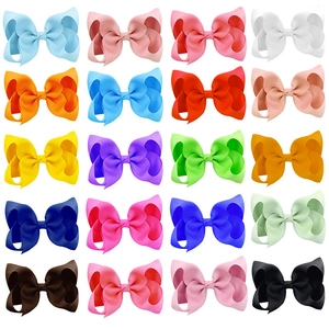 Close-up of 20 vibrant handcrafted 4-inch grosgrain ribbon hair bows in a grid display