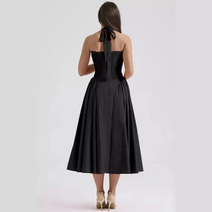 Slim fit black halter backless midi dress for women featuring a flared silhouette