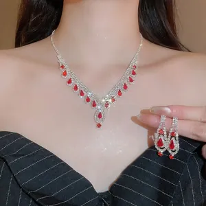 Luxury silver-tone jewelry set with red teardrop gems and sparkling tassels for women