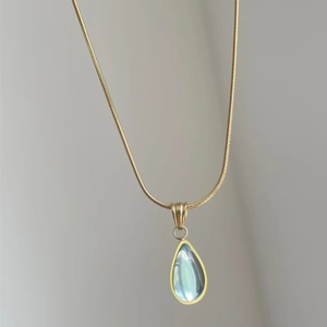 Vintage gold snake chain necklace with a light blue water drop gemstone pendant