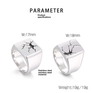 Macro view of men's stainless steel signet rings with black cracked stone texture