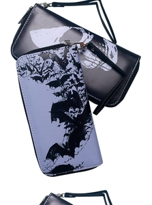 Close-up of leather zip wallets with skull and bat prints in black and purple tones