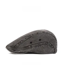 Side view of dark gray washed denim beret featuring metallic eyelets and vintage stitching