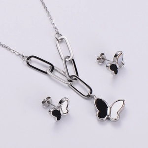Detailed macro shot of silver necklace and butterfly shell earrings jewelry set