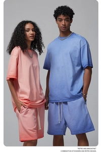 Lifestyle shot of couples in pink and blue washed cotton retro streetwear sets