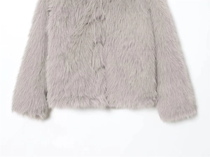 Detailed close-up of soft grey faux fur texture on the hooded jacket sleeves and body