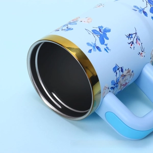 Detail view of the floral pattern and gold electroplated rim on the stainless steel tumbler