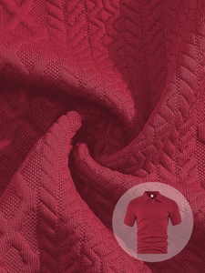 Macro detail of red knit polo shirt fabric featuring a 3D geometric jacquard texture