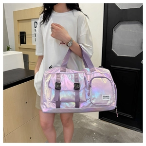 Detail of a shiny purple fitness bag with buckle and ZUOWANZI label, hand-held by a model
