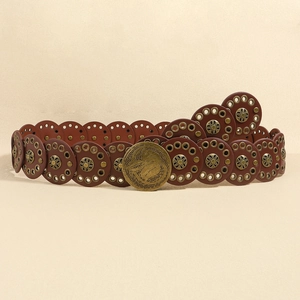 Macro detail of brown leather belt with vintage bronze studs and embossed round buckle