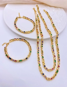 Detailed top view of gold necklaces and bracelets with colorful multi-shaped zircon stones
