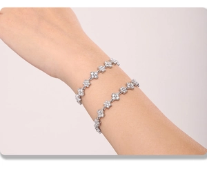 Detailed close-up of sparkling flower bracelet with micro-pave stones on wrist