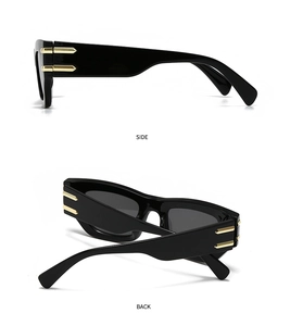 Détail de lunettes de soleil œil-de-chat noires avec décor de flèche dorée sur le côté