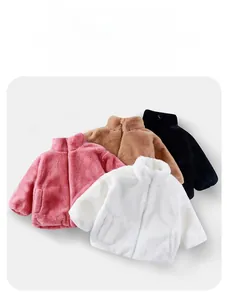 Close-up of fluffy faux rabbit fur jackets in pink, brown, white and black for kids