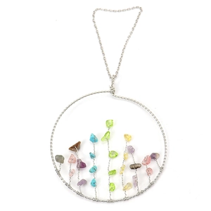 Detail of handmade Tree of Life wall hanging with colorful crystal stones and silver wire