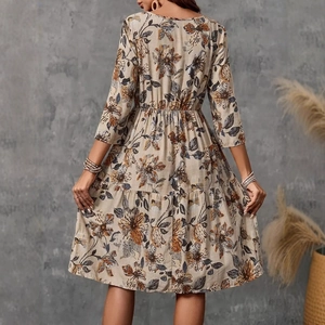 Rear view of floral tiered midi dress featuring tiered hem and bohemian flower print