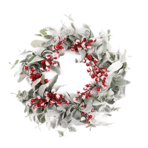 Christmas wreath with red berries, green eucalyptus leaves and heavy artificial snow