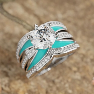 Macro shot of wide princess cut ring with emerald enamel and six-claw diamond setting