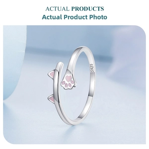 Detail of S925 sterling silver ring with pink enamel cat ears and paw print patterns