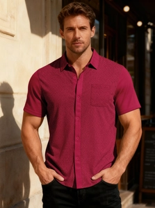 Detail of deep magenta short sleeve shirt showing textured diamond knit and front pocket