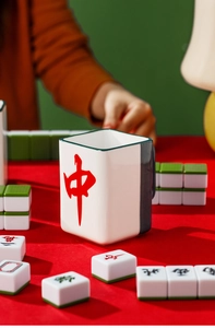 Close-up of square Mahjong ceramic mug with red character design on a leisure table