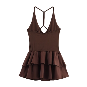 Detail of backless brown mini dress with crisscross straps and layered ruffle hemline