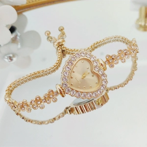 Close-up of golden heart-shaped watch with diamond bezel and adjustable drawstring chain