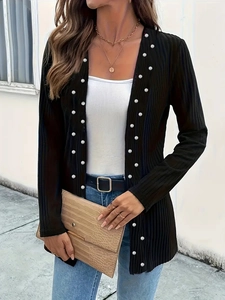 Close-up of black ribbed knit cardigan featuring elegant white pearl bead embellishments