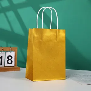 Golden metallic gift bag with white rope handles and high-gloss paper finish
