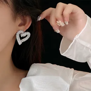 Exquisite hollow heart cubic zirconia stud earrings in a luxury nested double heart design