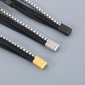 Macro view of men's multilayer braided leather bracelets with black, silver and gold magnetic clasps