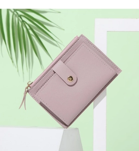 Detailed view of dust pink faux leather wallet with lychee grain and metal hardware