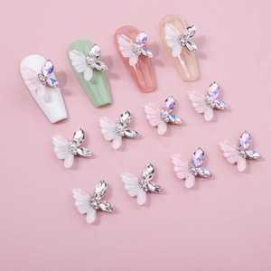 3D resin butterfly nail art charms with iridescent rhinestones and pearls on fake nails