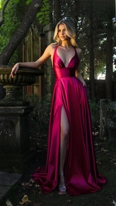 Detail of the elegant satin evening dress featuring a plunging V-neck and high leg slit
