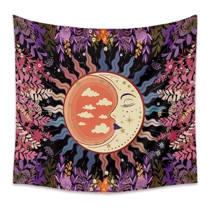 Detail of bohemian tapestry featuring sun and moon illustration with floral patterns