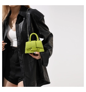 Mini neon green crossbody bag with beaded silver chain and textured lychee pattern