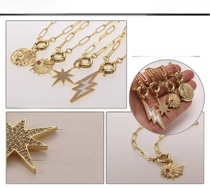 Detail of 18K gold plated paperclip chain with zircon sun, moon, and star pendants